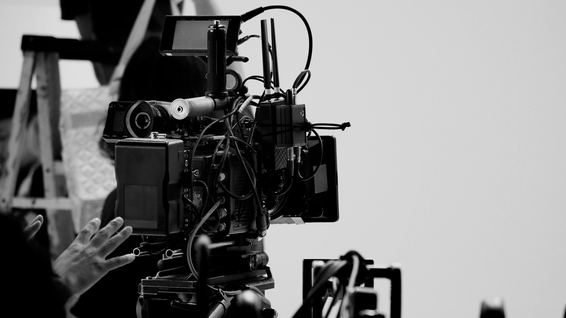 Film director and crew making commercial content advertising in studio. Filmmaker crew team with professional cinema equipment and video camera on the set. Technique of modern filming and advertising.