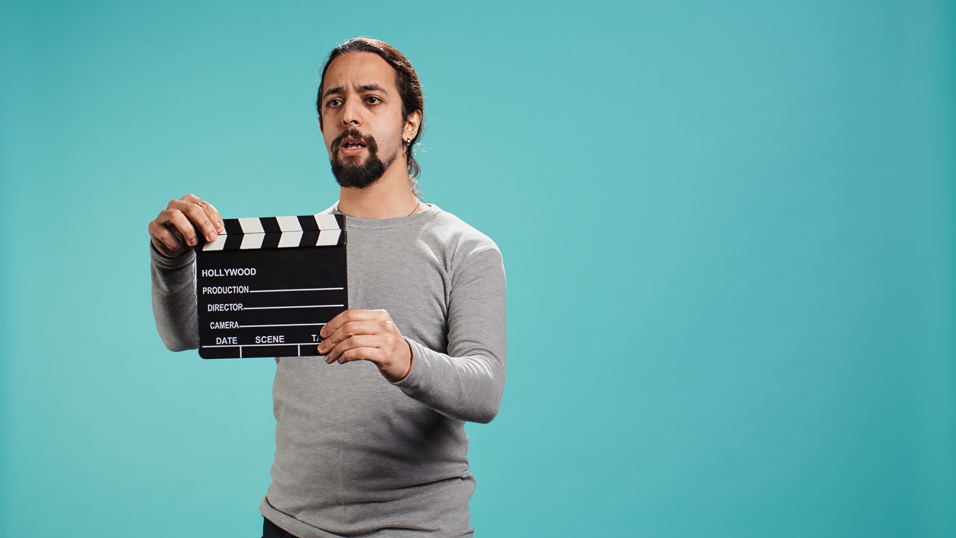 Movie director using clapper on set, filming video production